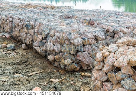Stone Walls, Protection From Backshore Erosion. Stones In A Metal Mesh. Gabion Wall Constructed Usin