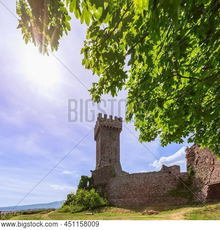 Radicofani - Italy. June 04, 2021: Midday Sun And Endless Sky Over Medieval Brick Walls Of Rocca Of 