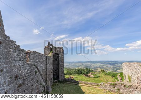 Radicofani - Italy. June 04, 2021: Ruins And Remains Of The Base Of Radicofani Fortress Wall With A 