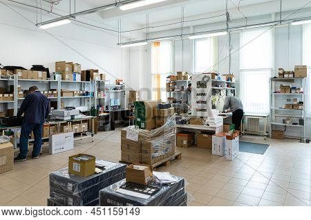 Minsk, Belarus - Dec 15, 2021: Photo Of A Warehouse With Boxes And Workers. Modern High-tech Plant F