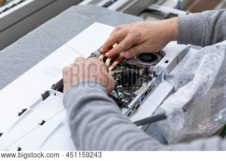 Minsk, Belarus - Dec 15, 2021: Photo Of Hands Of A Man Who Assembles A Computer Monitor System Block