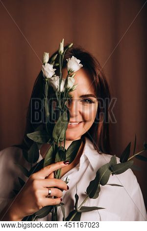 Portrait Of A Young Beautiful Girl In A White Shirt, Who Holds A Eustoma Flower In Her Hand, Coverin