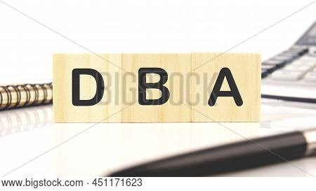 Dba A Word Written On Wooden Cubes On A White Background.
