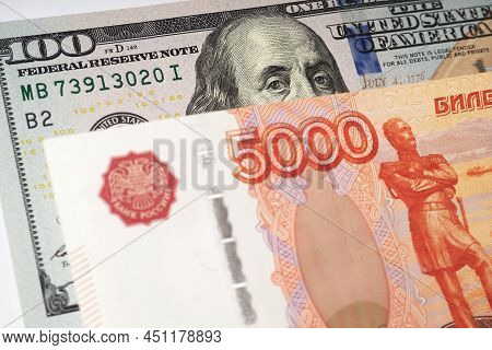 Fragments Of Russian And American Paper Money Closeup. Ruble And Dollar. A Banknote Of 5000 Rubles A