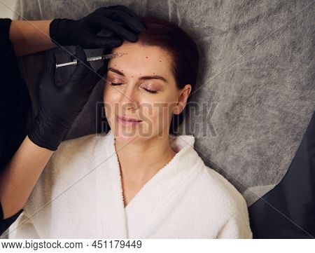 Close-up Beautiful Dark-haired Middle Aged European Woman Getting Beauty Injection Of Hyaluronic Aci