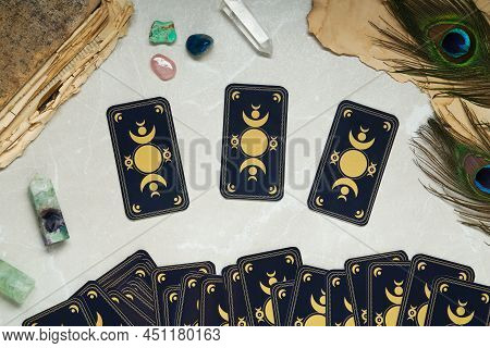 Tarot Cards, Peacock Feathers, Gemstones And Old Book On Light Table, Flat Lay. Reverse Side