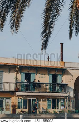 Nice, France - March 10, 2022: People Relaxing At The Outdoor Tables Of Babel Babel Restaurant And B