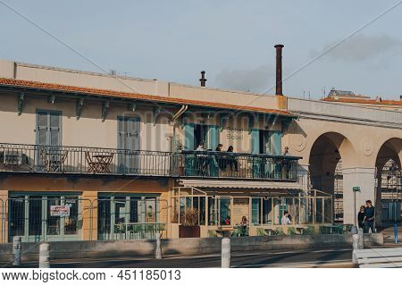 Nice, France - March 10, 2022: People Relaxing At The Outdoor Tables Of Babel Babel Restaurant And B