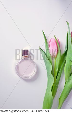 Fragnance And Pink Tulip. Romantic Composition. A Bottle Of Perfume, A Bouquet Of Tulips And An Enve