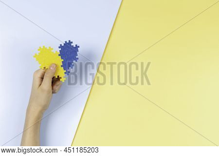World Down Syndrome Day Background. Child Hands Holding Blue And Yellow Down Syndrome Awareness Day 