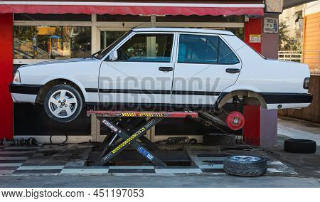 Antalya; Turkey - March 04 2022: Yellow Tofas Dogan Car On A Lift At A Tire Shop