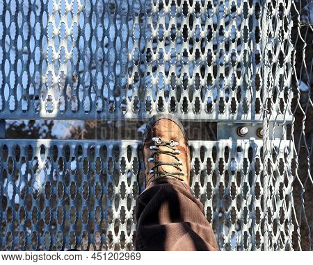 Lightweight Boot Of Man That Walks On The Suspension Brdige In Stainless Steel