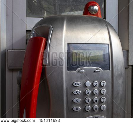 Payphone Close-up. Phone With A Red Tube At A Train Station In Italy. Telecommunication\nconcept.