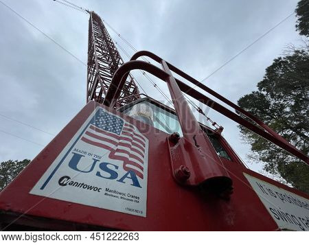 Augusta, Ga Usa - 03 19 22: Manitowoc Red Crane Construction Scene Cloudy Rainy Day Made In Usa Sign