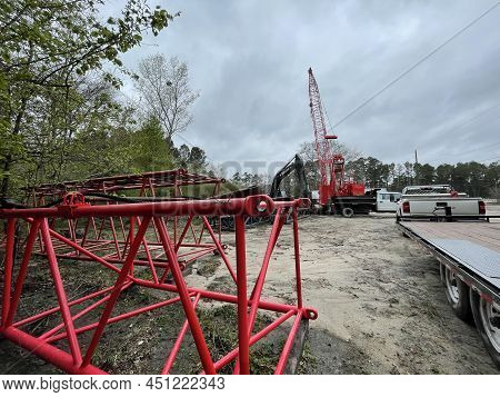 Augusta, Ga Usa - 03 19 22: Manitowoc Red Crane Construction Scene Cloudy Rainy Day Back Lot View
