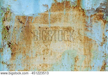 Brown Beige Abstract Background With Orange Blue Hues. A Rust-eaten Textured Sheet Of Metal With Rem