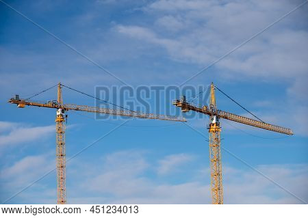 Calgary, Alberta - February 27, 2022: Pcl Construction Cranes With Blue Sky And Clouds.