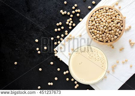 Soy Milk With Soybeans On Dark Background.
