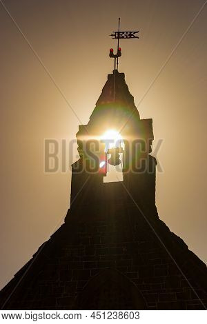 Silhouette Of Old Church In Bulla Victoria With Sunset Glinting Through The Bell Tower