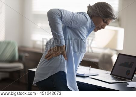 Middle-aged Woman Touch Lower Back, Suffer From Sudden Backache