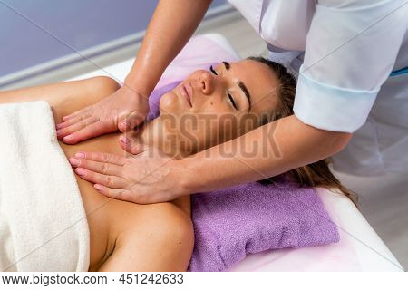 Facial Massage. A Woman Is Given A Massage In A Beauty Salon. Close-up.