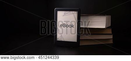 E Reader. Digital E Book, Library Reader Tablet With Books On Dark Background. Online Education Cour