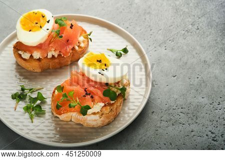 Sandwich With Delicious Toppings Smoked Salmon, Eggs, Herbs And Microgreens Radish, Black Sesame See