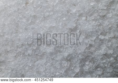 Coarse White Iodized Salt. Detailed Background Texture Macro Close-up. Salt Crystals Of Different Si