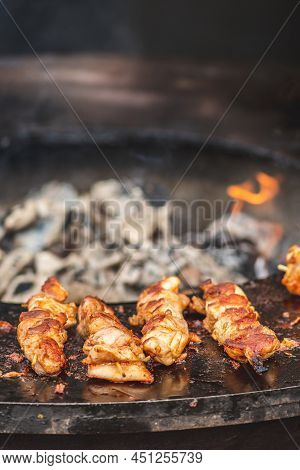 Preparing Chicken Meat Skewers, Grilled Or Roasted In A Barbecue On An Open Fire And Flames, Shashli