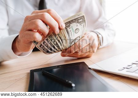 Businessman Counting Petty Cash Us Dollar Banknotes In Office, Selective Focus