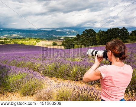 Mature Tourist Woman With Camera Taking Travel Photo From Provence Landscape With Purple Lavender Fi