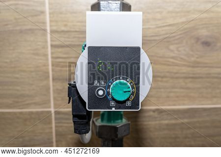 Water Circulation Pump For Underfloor Heating In A Modern Gas Boiler Room Lined With Ceramic Tiles, 