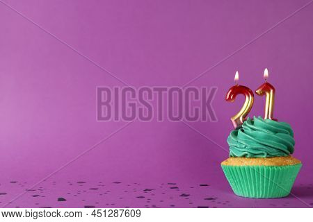 Delicious Cupcake With Number Shaped Candles On Purple Background, Space For Text. Coming Of Age Par