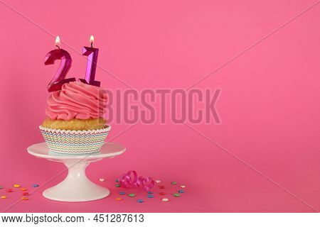 Delicious Cupcake With Number Shaped Candles On Pink Background, Space For Text. Coming Of Age Party