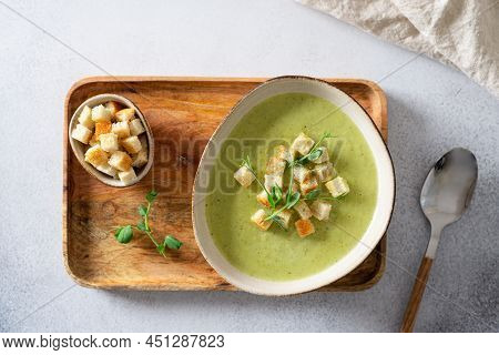 Detox Cream Soup Of Green Vegetables Broccoli, Green Peas, Spinach Served With Crutons And Micro Gre