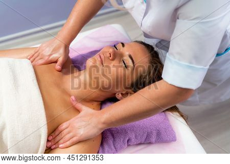 Facial Massage. A Woman Is Given A Massage In A Beauty Salon. Close-up.
