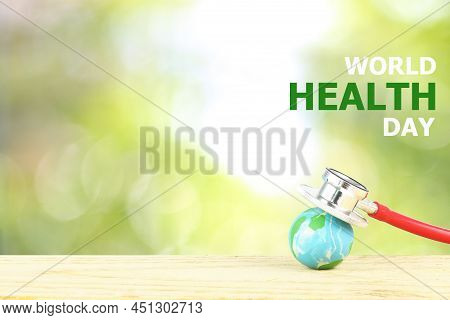 World Health Day Concept - Blue Earth And  Red Stethoscope With Text