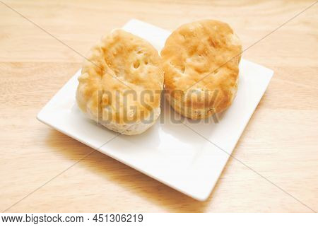 Two Fresh Baked Biscuit On A White Plate