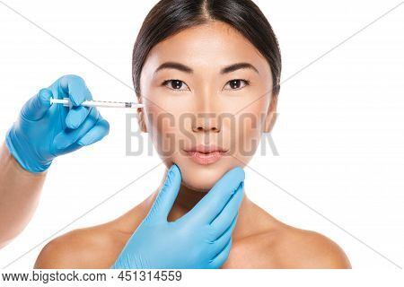 Asian Woman During Cheekbone Modulation Or Filler Injection Procedure