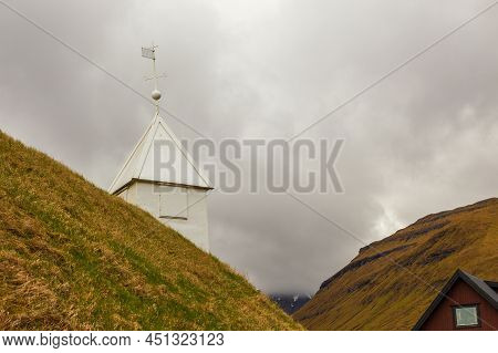 View Of The Kollafjordur Church, Kirkja In Small Village On Streymoy Island. Cloudy Day. Kollafjordu