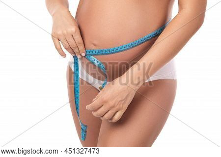 Pregnant Woman With Measuring Tape Is Checking Her Belly Girth