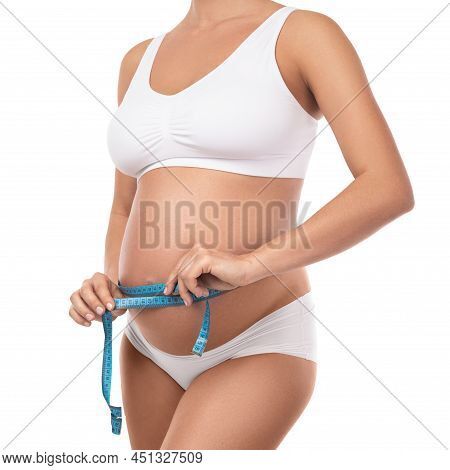Pregnant Woman With Measuring Tape Is Checking Her Belly Girth