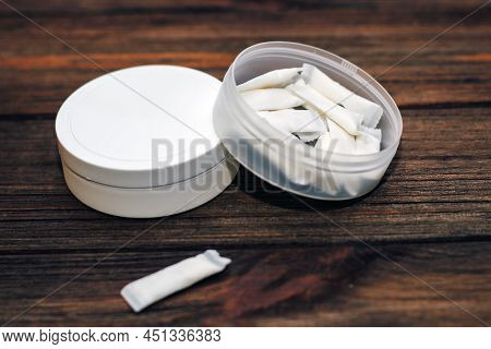 Snus Box With Nicotine Pouches On Wooden Background.