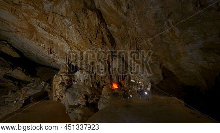 Tourist Caves In Rocks. Action. Huge Rock Caves With Hiking Trails. Inside Large Rocky Cave In Dark