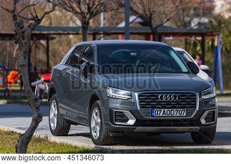 Side; Turkey - March 03 2022:    Gray Audi Q2  Is Parked  On The Street On A Warm  Day Against The B
