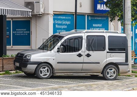 Side; Turkey - March 04 2022:   Silver  Fiat Doblo   Is Parked  On The Street On A Warm Summer Day A