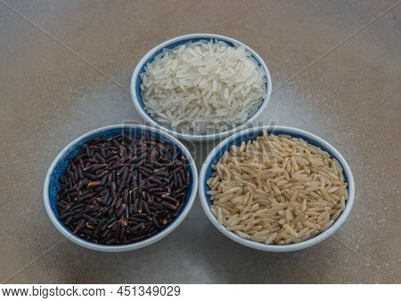 Various Types Of Rice : Brown Rice, Jasmine Rice, Riceberry Ceramic Cup. Organic Raw Rice Collection