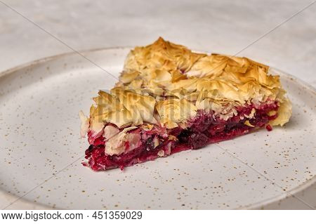 Piece Of Homemade Cherry Pie From Filo Dough On White Plate. Selective Focus, Close Up