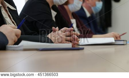 Hands Of An Elderly Woman Participating In A Meeting Or Negotiations During The Coronavirus Pandemic