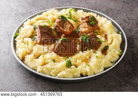 Greek Sofrito Slow Braised Beef With Spicy Gravy Garnished With Mashed Potatoes Close-up In A Plate 